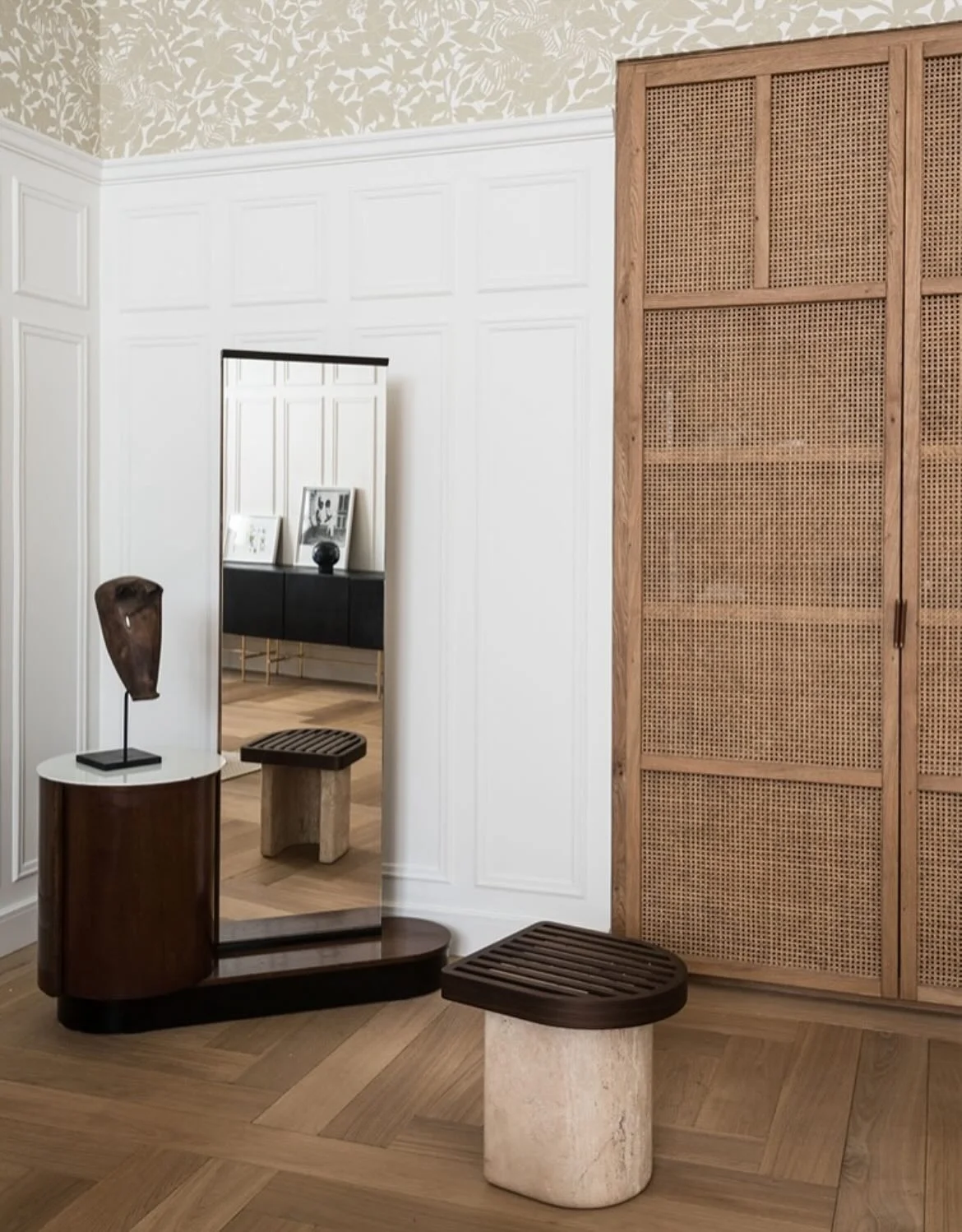 This Paris apartment balances richness and restraint - woven cane, soft whites, carved stone, sculptural accents. The cu